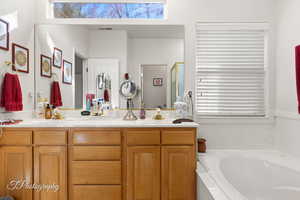 Bathroom featuring vanity and shower with separate bathtub