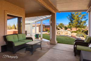 View of patio featuring an outdoor living space and a pergola