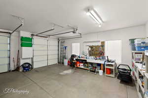 Garage with a garage door opener and a workshop area