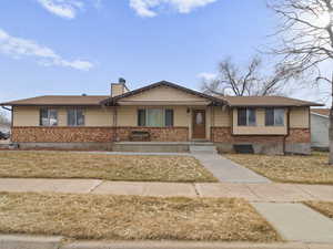 Ranch-style home featuring a front yard