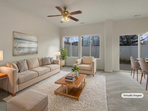 Carpeted living room featuring ceiling fan