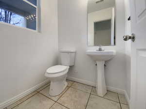 Bathroom featuring tile patterned flooring and toilet