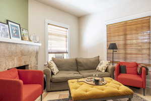 Living room with cooling unit and a tile fireplace