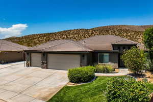 View of front of property with a garage and a mountain view