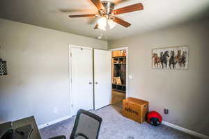 Home office featuring ceiling fan and light colored carpet