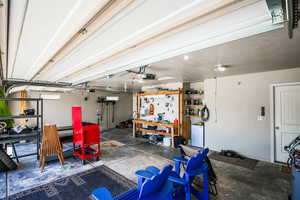 Garage with a garage door opener and a workshop area