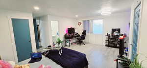 Bedroom with light hardwood / wood-style floors