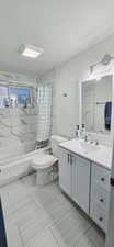 Full bathroom featuring shower / tub combo with curtain, vanity, and toilet