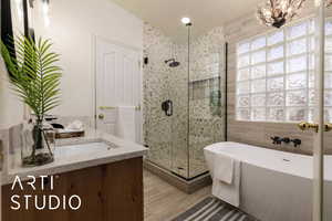 Bathroom featuring vanity and plus walk in shower