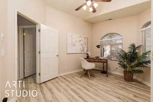 Office space with ceiling fan and light hardwood / wood-style flooring