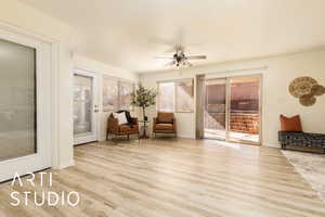 Living area with light hardwood / wood-style flooring and ceiling fan