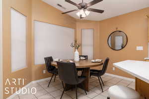 Tiled dining room featuring ceiling fan