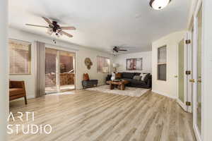 Living room with ceiling fan and light hardwood / wood-style flooring