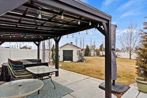 View of patio featuring a shed