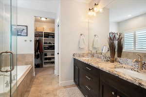 Bathroom with vanity, independent shower and bath, and tile patterned flooring