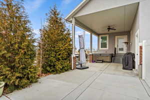 View of patio / terrace featuring a hot tub and ceiling fan