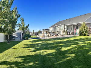 View of yard with a storage unit