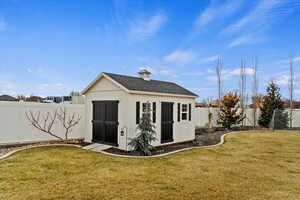 View of outbuilding featuring a yard