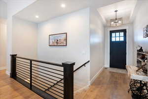 Foyer with a notable chandelier and wood-type flooring