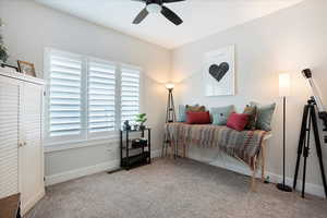 Carpeted bedroom with ceiling fan