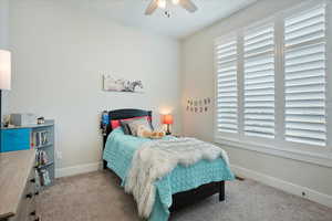 Carpeted bedroom with ceiling fan