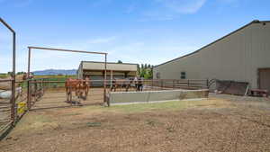 View of yard with an outdoor structure, an exterior structure, a view of countryside, and a mountain view
