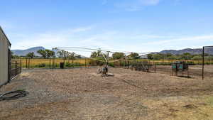 View of yard featuring a mountain view, a rural view, and an exterior structure