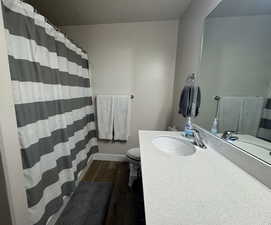 Bathroom featuring vanity, a textured ceiling, and toilet, shower/tub