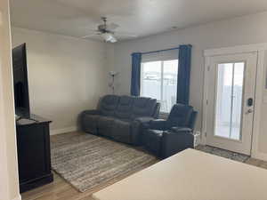 Living room featuring light LPV flooring and ceiling fan