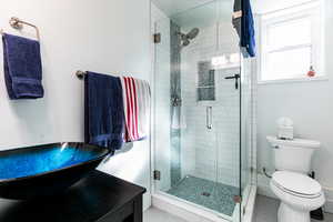 Bathroom with an enclosed shower and toilet