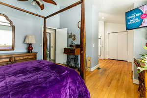 Bedroom featuring ceiling fan, vaulted ceiling, and light hardwood / wood-style floors