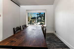 Dining area featuring dark hardwood / wood-style floors and a textured ceiling