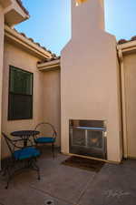 View of patio with exterior fireplace