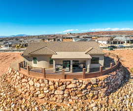 Back of property with a mountain view and a patio