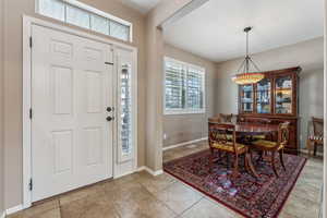 Entrance foyer with light tile patterned floors