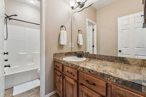 Bathroom with vanity, tile patterned floors, and  shower combination