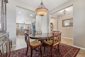 Dining space with light tile patterned flooring