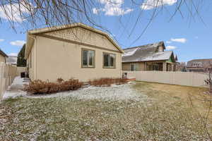 Back of property featuring central AC and a lawn