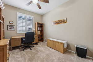 Carpeted office space with ceiling fan