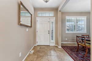 Entrance foyer with light tile patterned floors