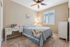 Carpeted bedroom with ceiling fan