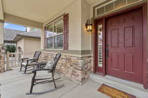 View of exterior entry with a porch