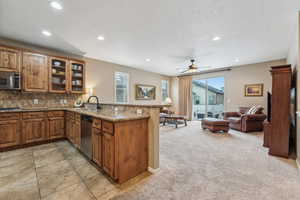 Kitchen featuring sink, stainless steel appliances, kitchen peninsula, and a healthy amount of sunlight