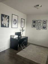 Office space featuring dark hardwood / wood-style flooring