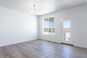 Interior space with a chandelier and light wood-type flooring