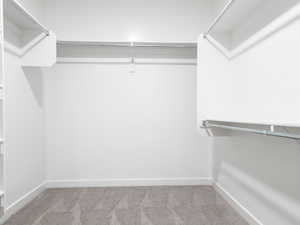 Walk in closet with carpet floors