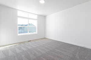 Empty room featuring light carpet