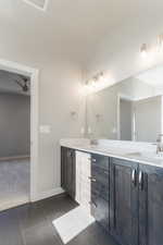 Bathroom with vanity, tile patterned floors, and ceiling fan