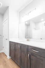 Bathroom with hardwood / wood-style flooring and vanity