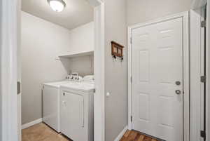 Laundry room featuring washer and clothes dryer and a textured ceiling